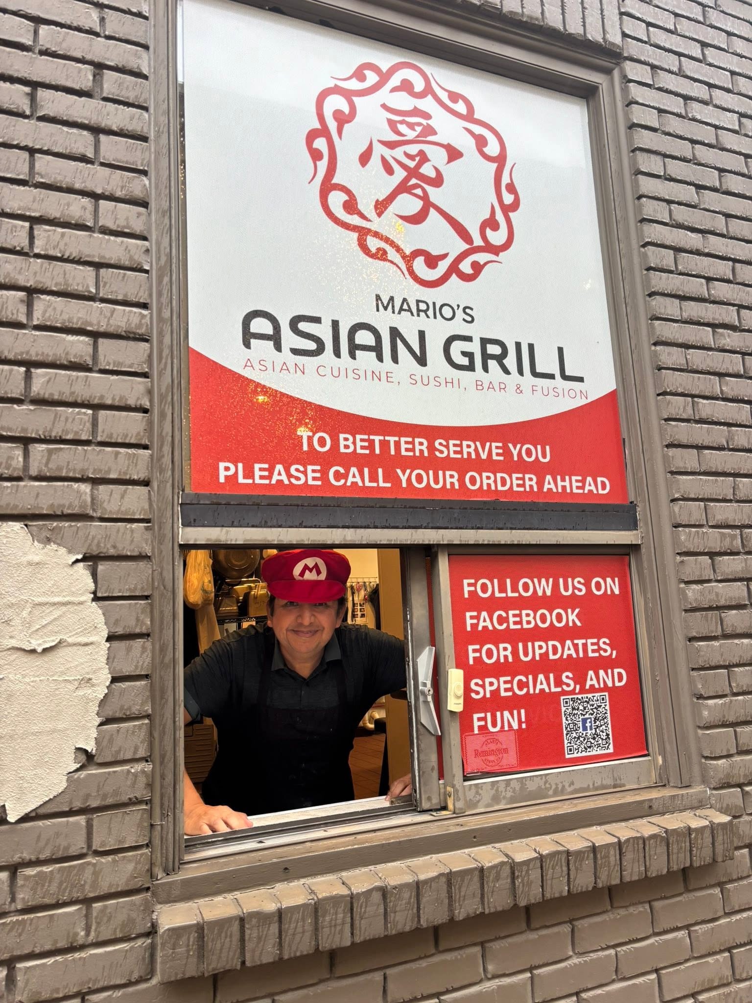 Owner at the drive-through window in his Mario hat