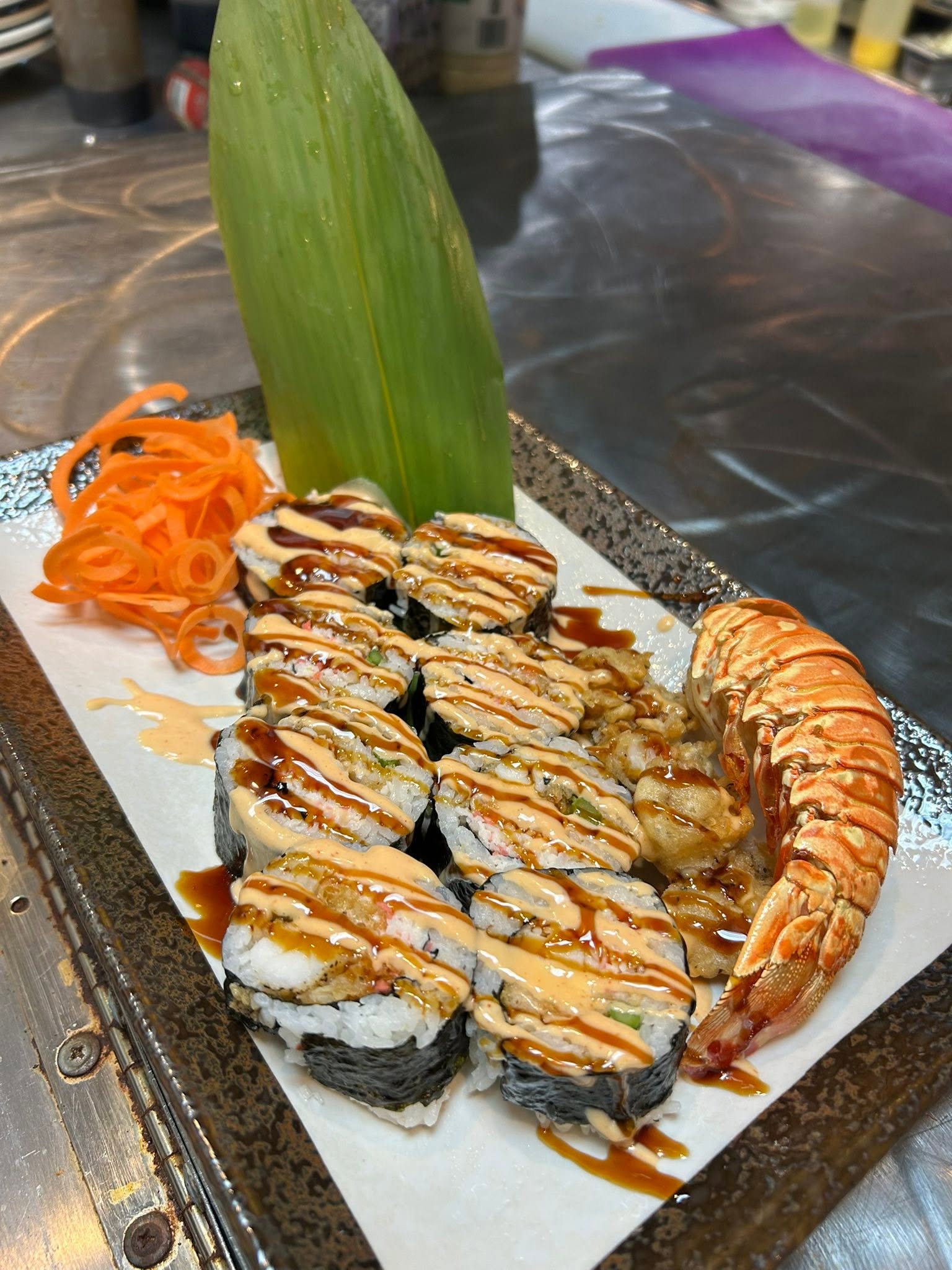Specialty roll with shrimp on a Mario's branded slate board