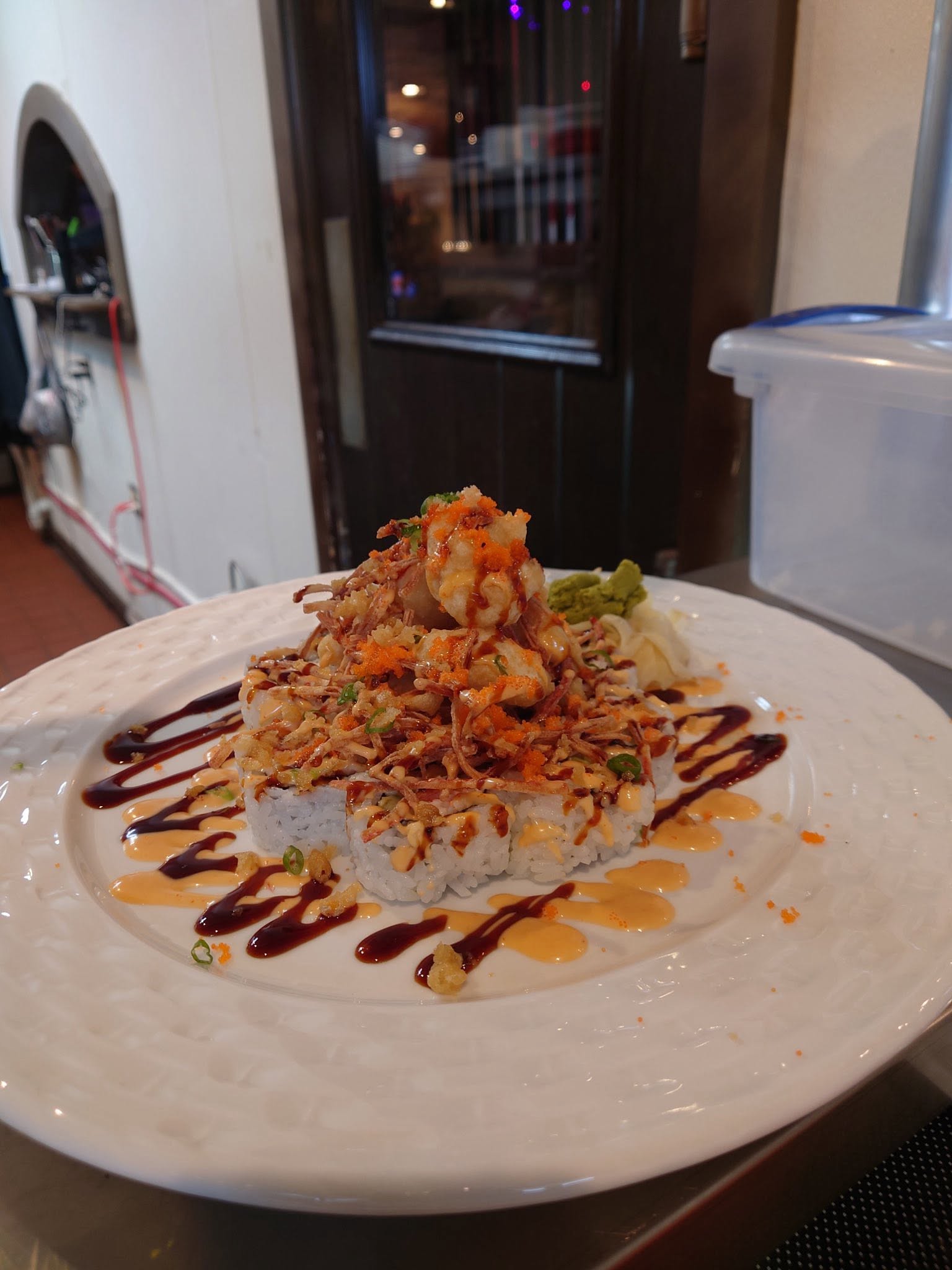 Specialty roll topped with crispy onions and sauces