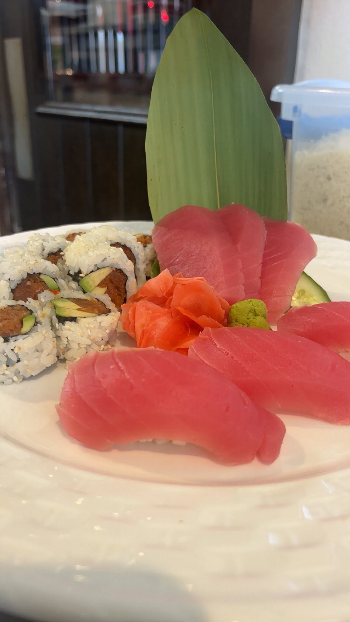 Tuna sashimi and spicy tuna roll with pickled ginger and wasabi