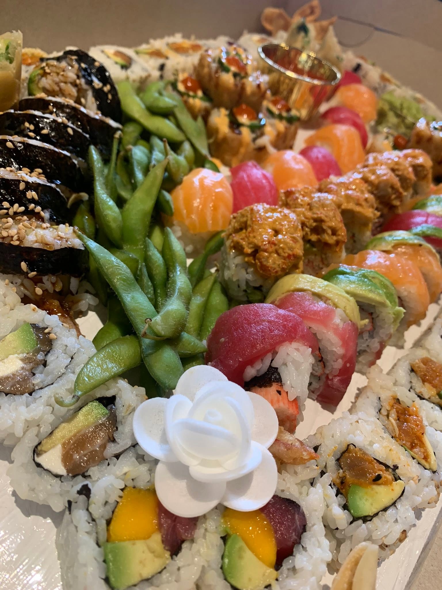 Party platter with assorted rolls, edamame, and starters at Mario's Asian Grill